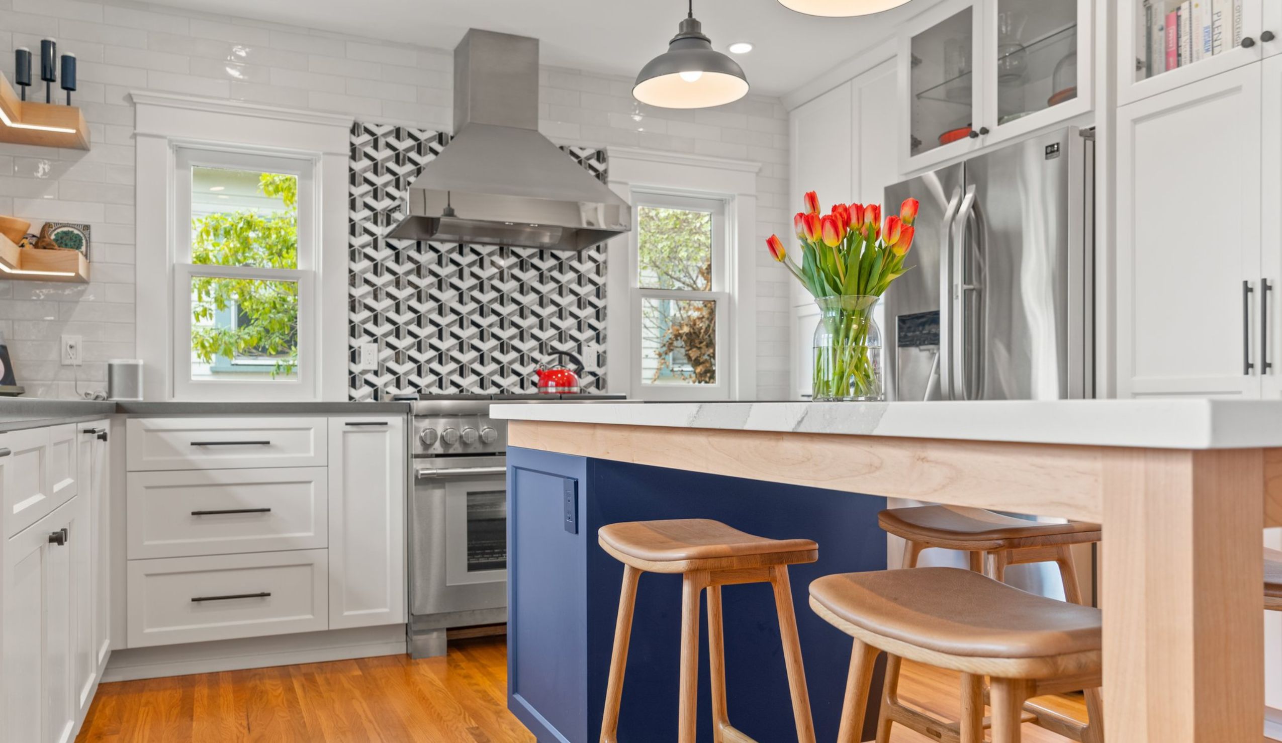 San Diego kitchen remodel with blue island, white shaker cabinets, stainless appliances and black-and-white range backsplash.