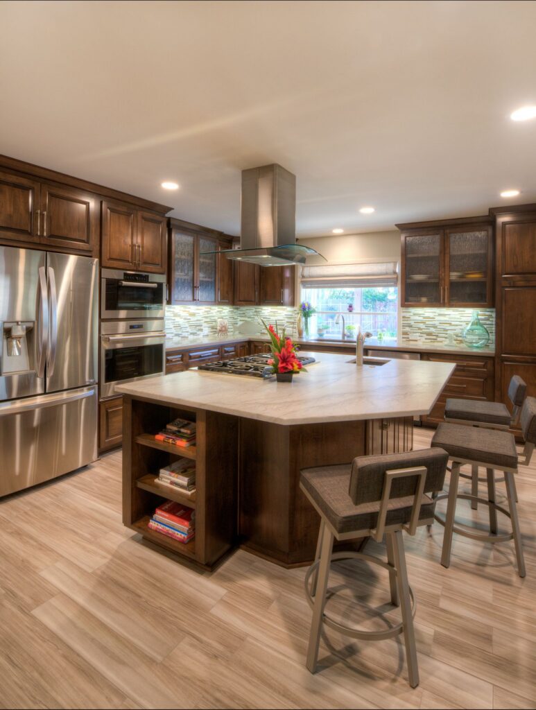 Mira Mesa kitchen remodel with dark wood cabinetry, large island, cooktop, prep sink, seating and stainless appliances.