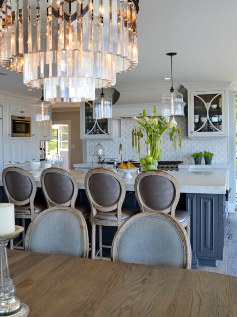 Mission Hills kitchen remodel with white cabinetry, dark island, stone counters, pendant lighting and dining area.