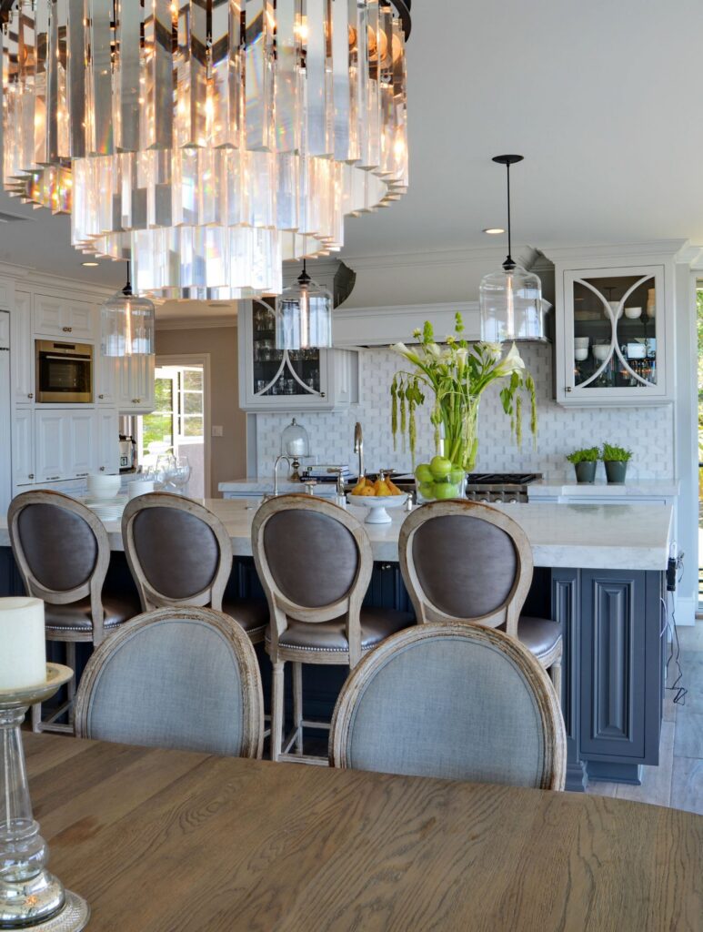 Mission Hills kitchen remodel with white cabinetry, dark island, stone counters, pendant lighting and dining area.