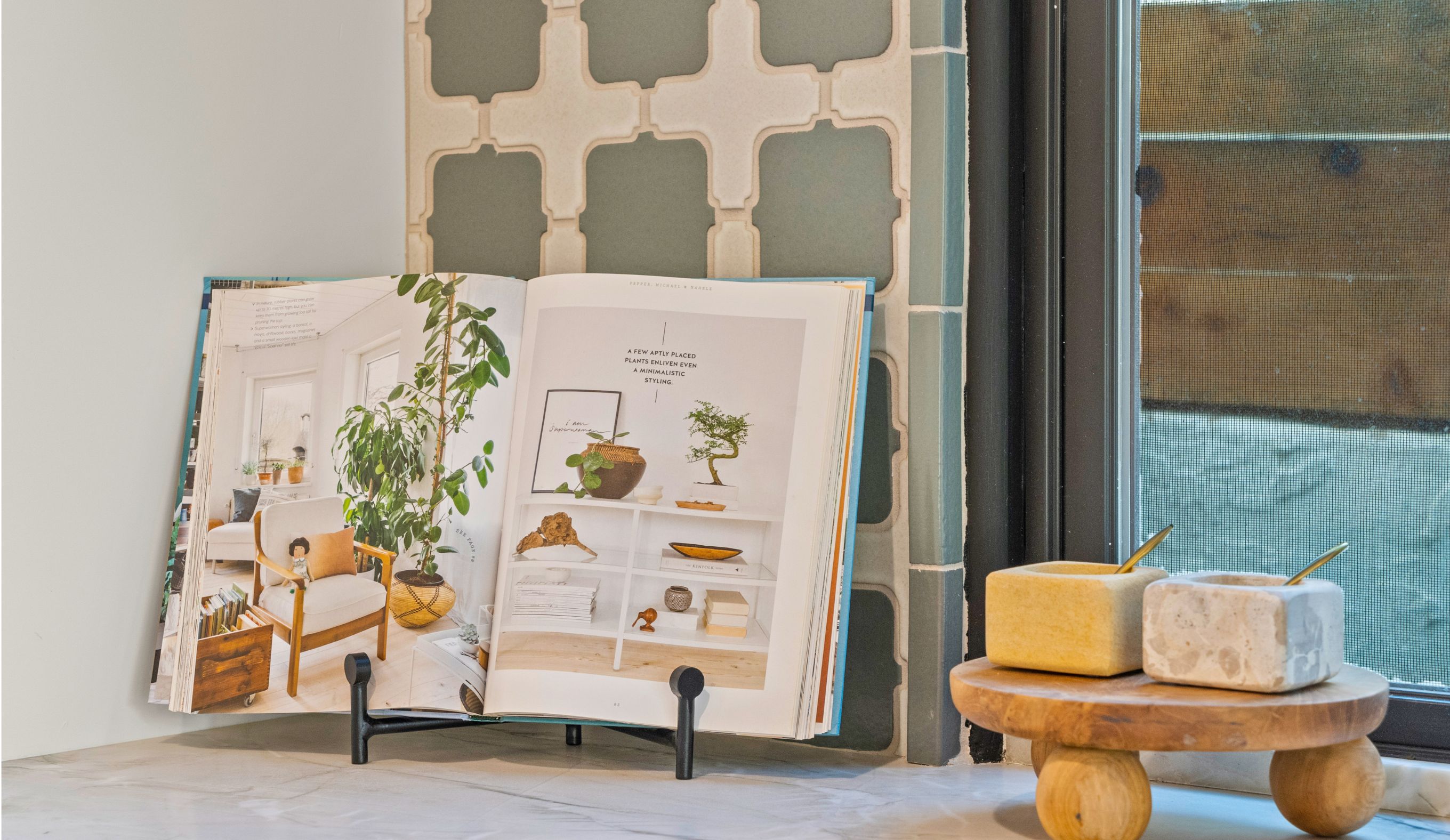 Mission Hills kitchen detail with patterned tile backsplash, black-framed window, stone countertop and cookbook display