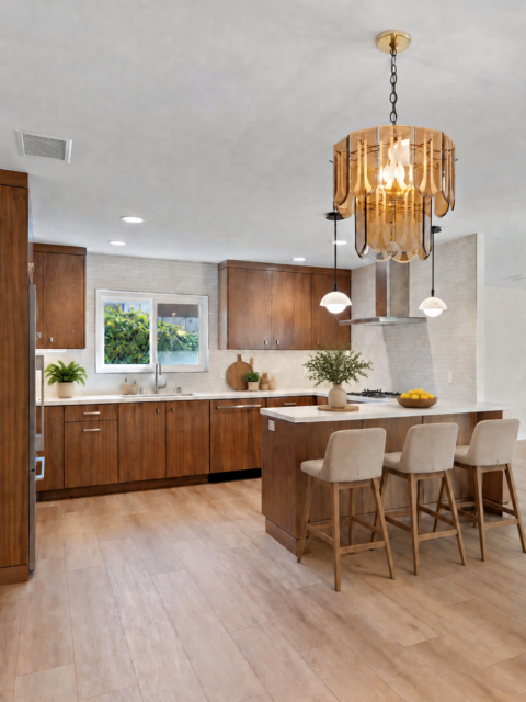 Clairemont living space with exposed wood ceiling beams, ceiling fan, sliding glass doors and light wood flooring.