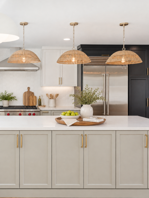 Clairemont kitchen remodel with large island, white cabinetry, farmhouse sink, woven pendants and wood-look flooring.