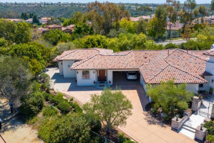 Aerial view of the attached ADU and main home with Mediterranean-style tile roofing and surrounding landscaping.