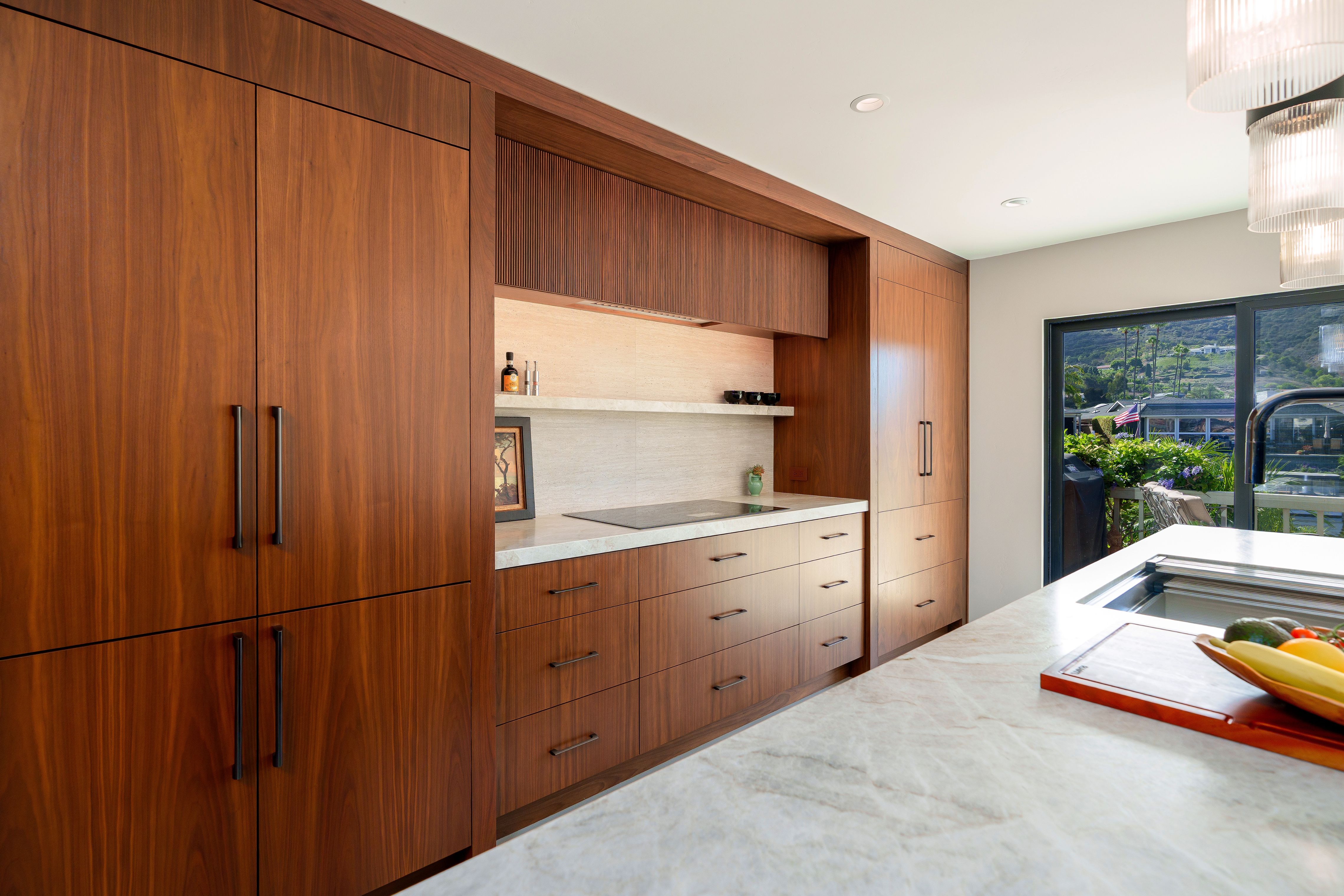 Living room with white leather sectional, wall-mounted TV, black-framed sliding doors, sealed concrete floor and wood slat wall