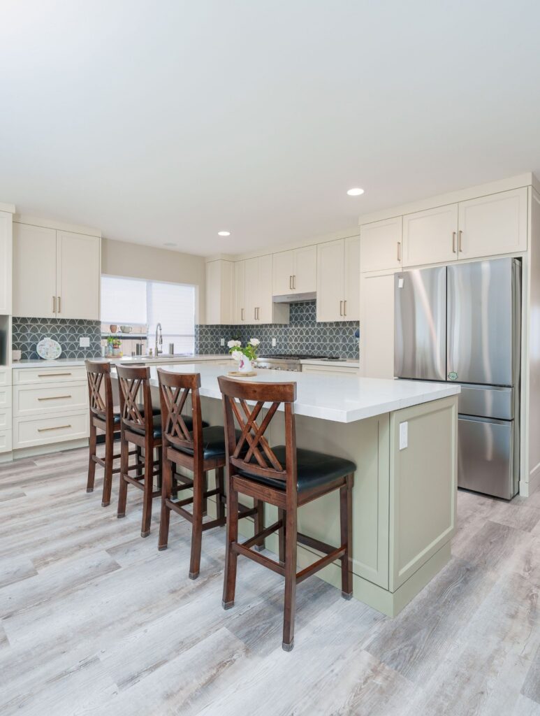 Mira Mesa whole-home remodel kitchen with sage green island, four barstools, cream shaker cabinets and fan tile backsplash